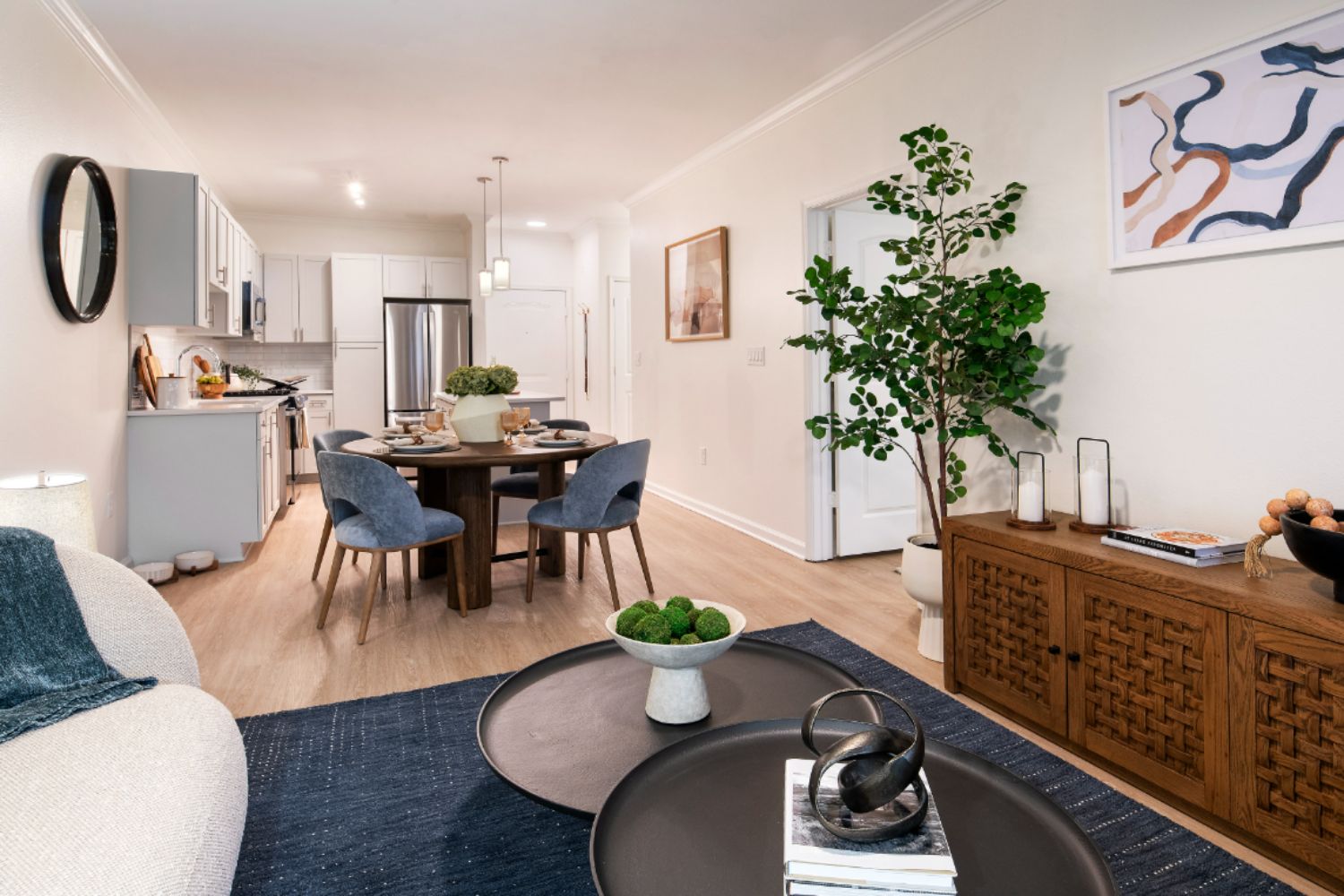 Blue rug with tan couch and console