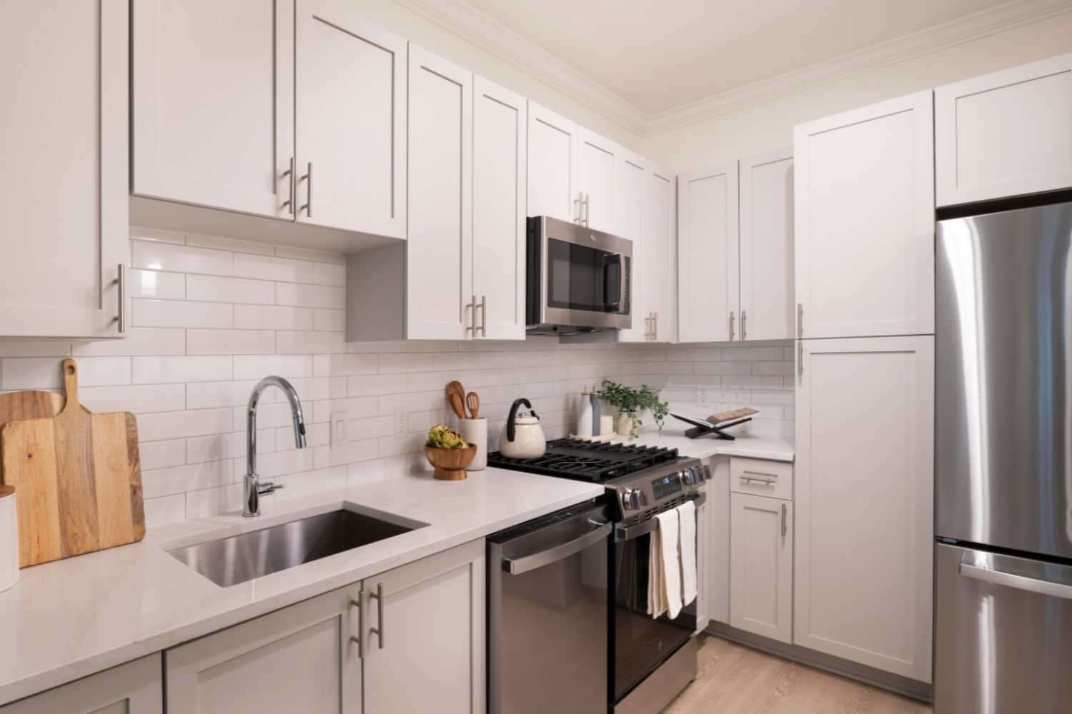 Kitchen with white stone counters and cabinets