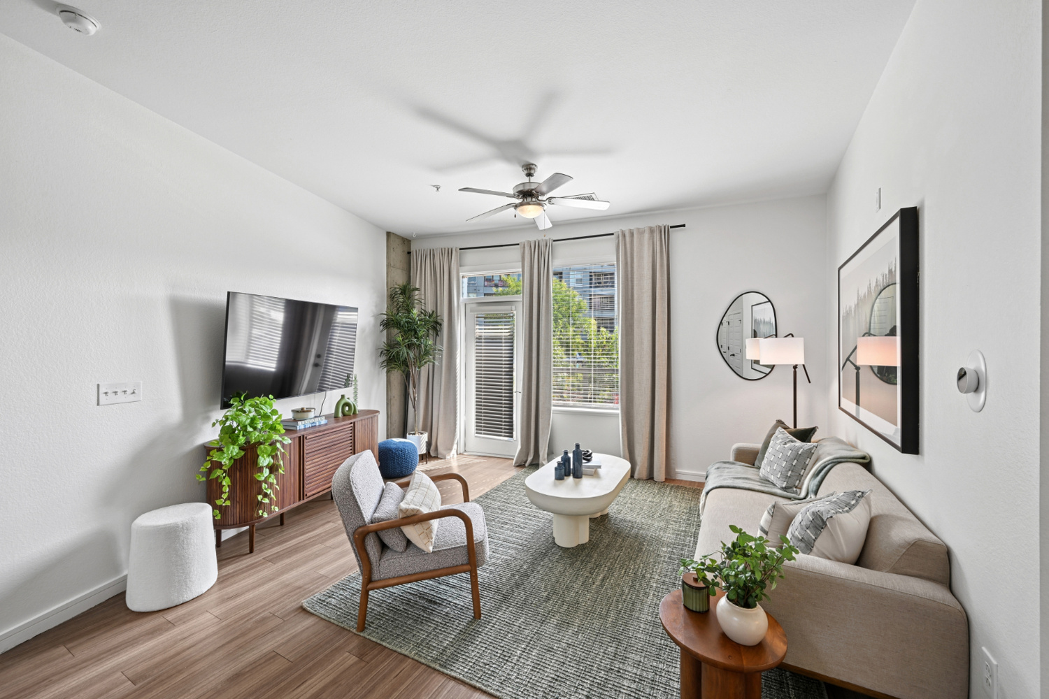 An Aera RiNo apartment living room in Denver features lounge seating and a glass door.