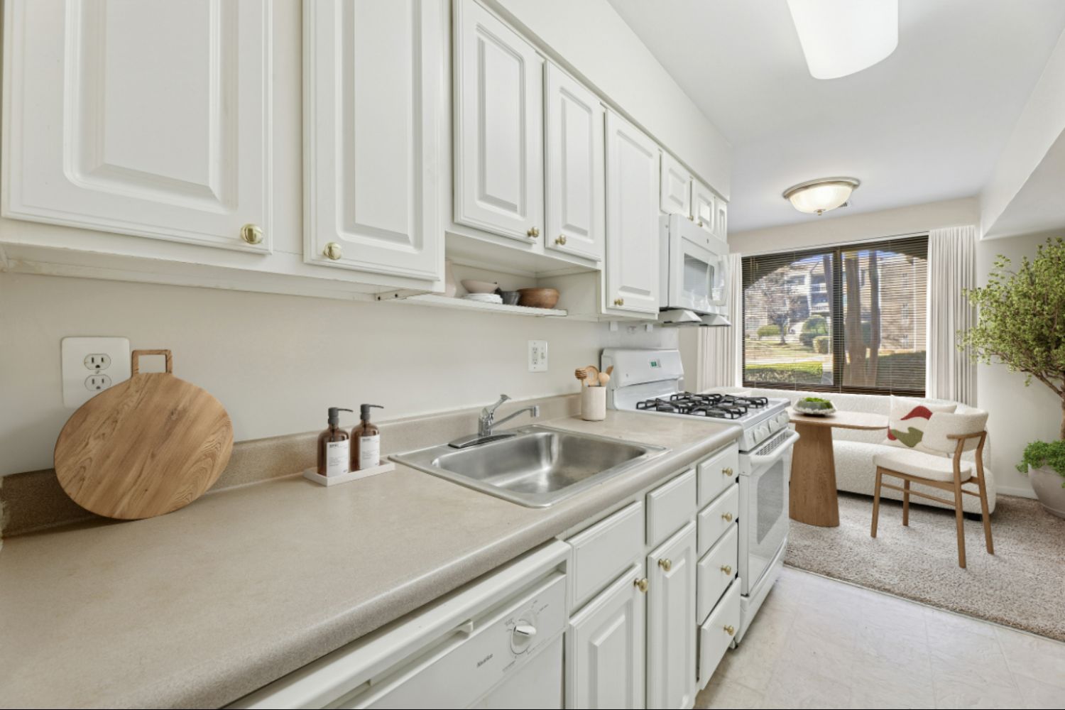 Kitchen counter with dining room chairs in distance