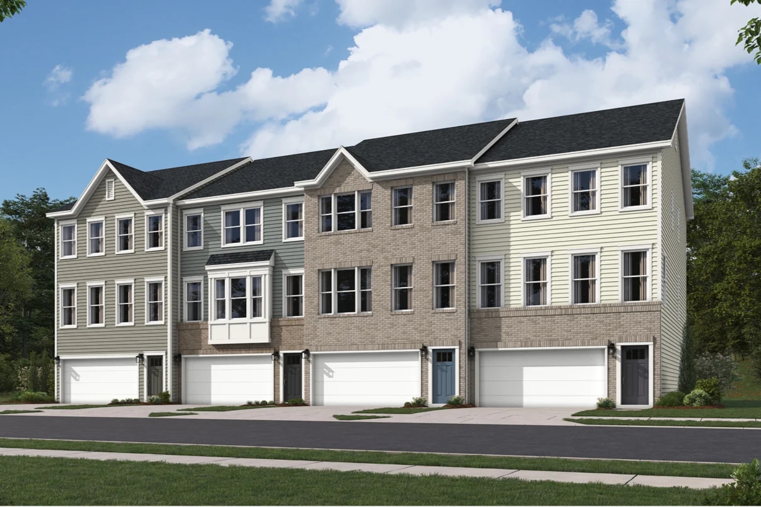 Row of modern townhouses with garages and greenery in the foreground under a blue sky.