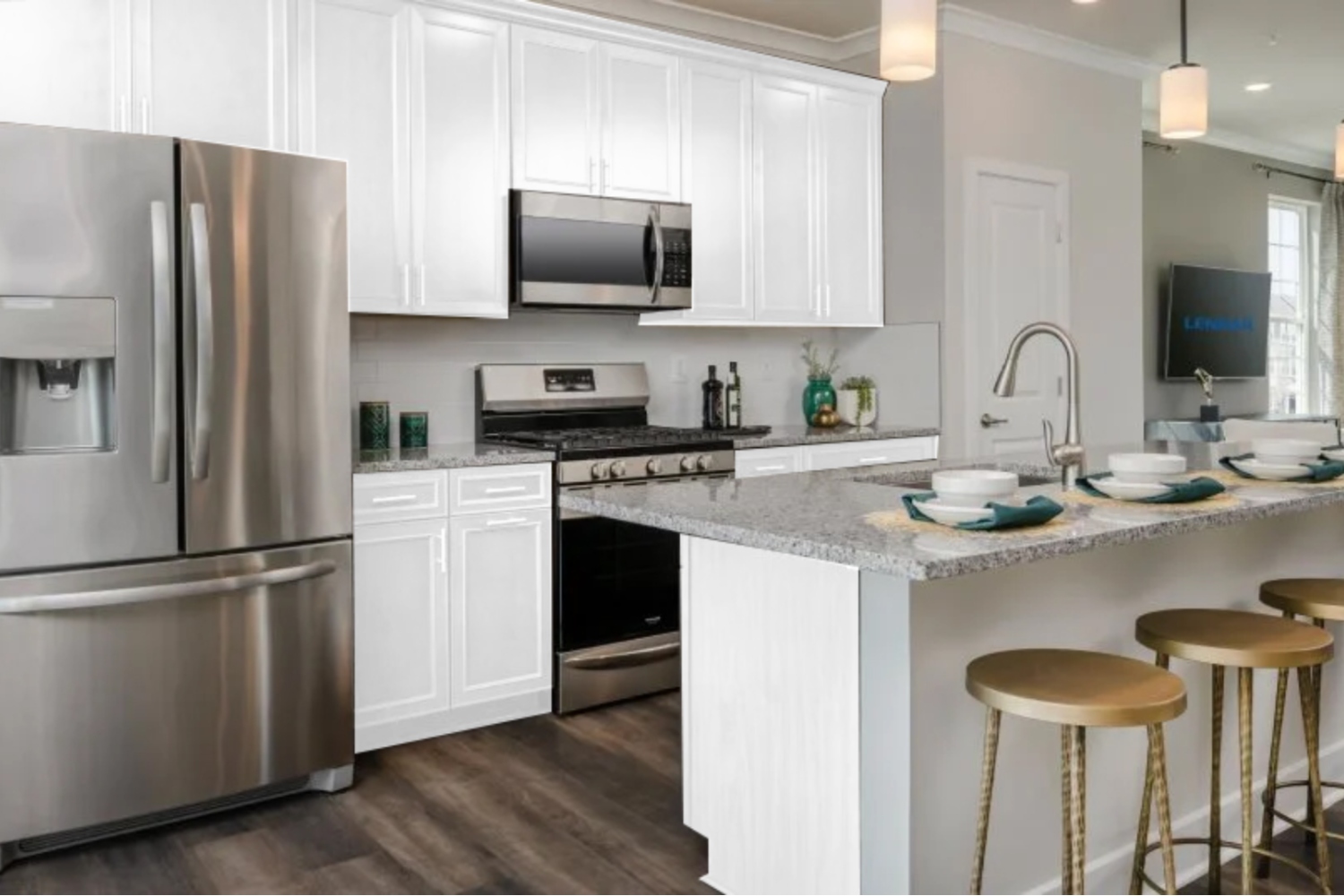 Modern kitchen with stainless steel appliances and white cabinetry.