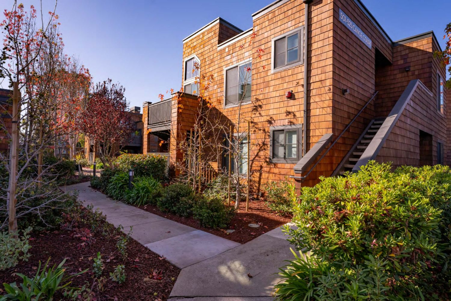 Apartment grounds with lush greenery and landscaped paths at Indian Creek in Redwood City