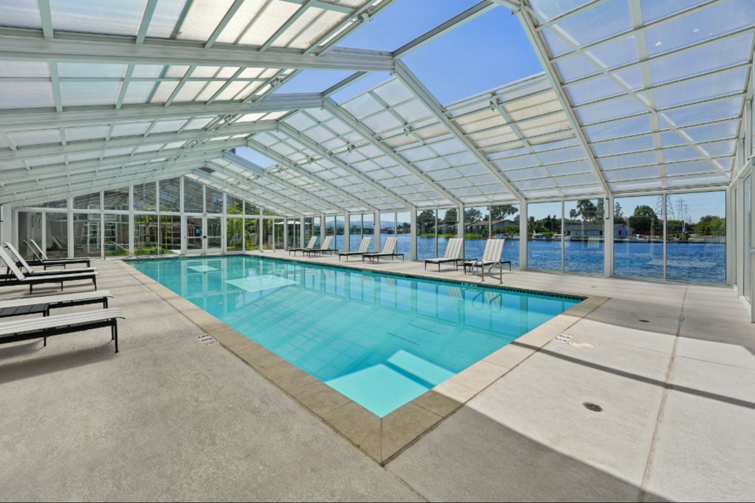 greenhouse-style pool house with swimming pool