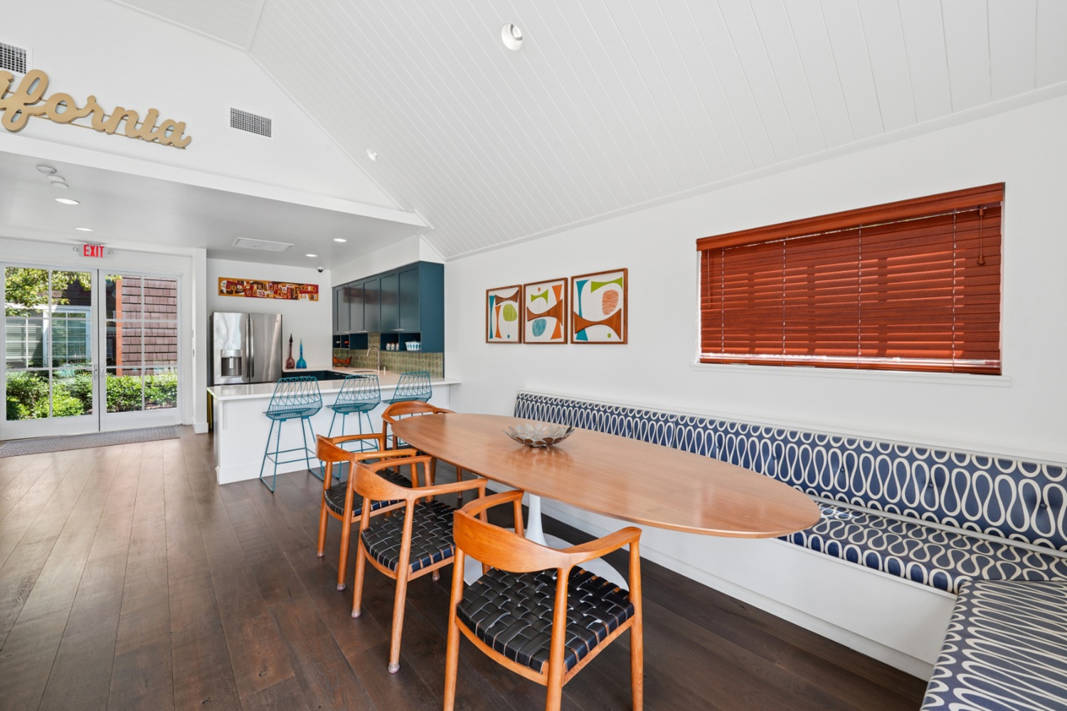 Resident clubhouse at Sunnyvale apartment community with large windows and seating