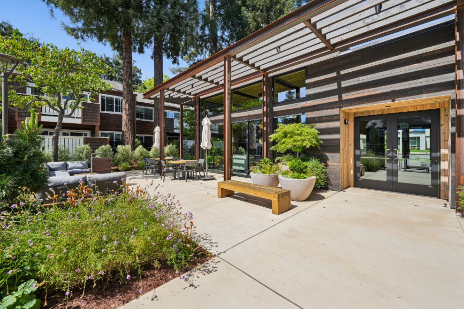 Clubhouse entrance at Peartree Apartments with landscaped walkway