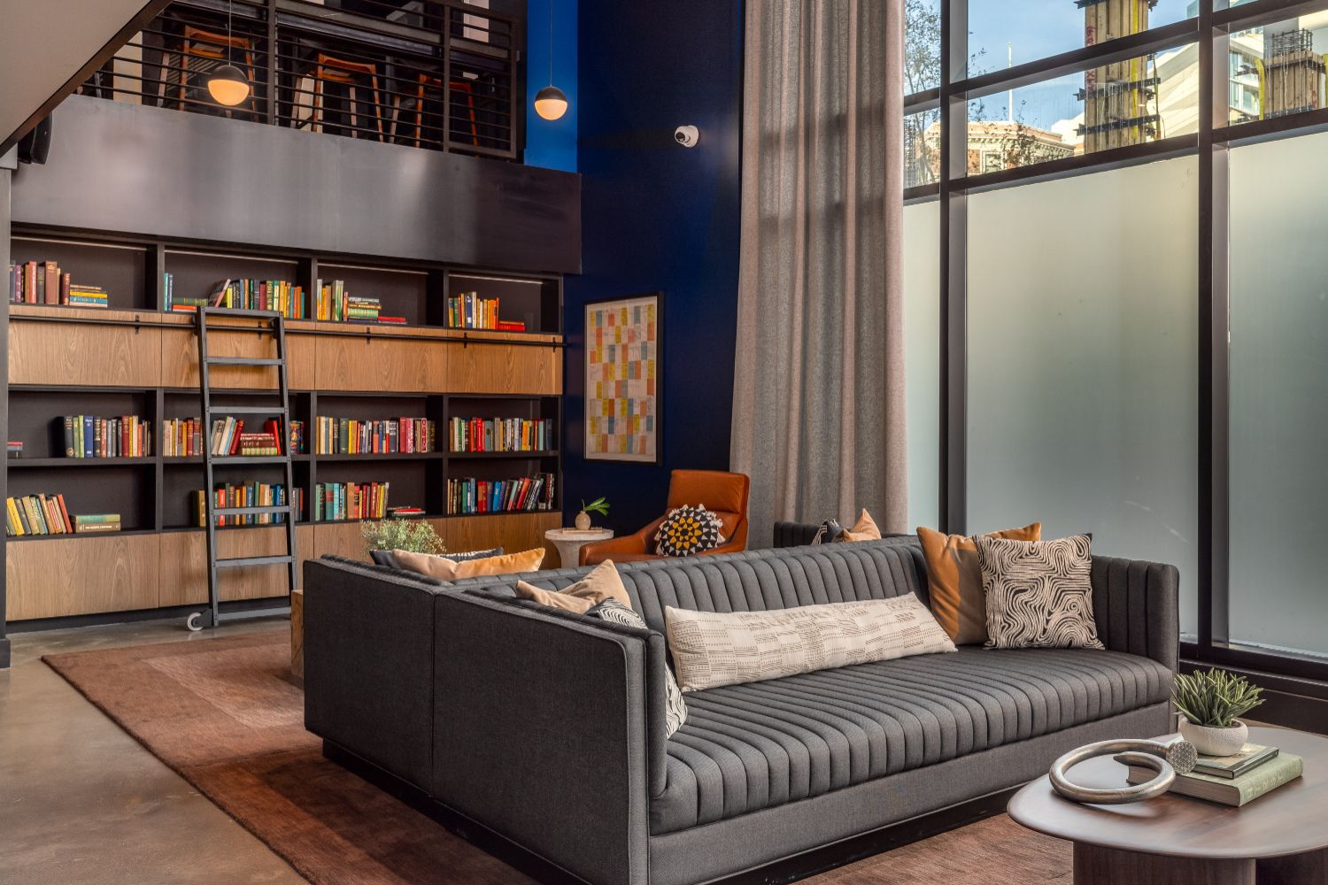 Luxury apartment lounge with books, seating, and relaxed ambiance
