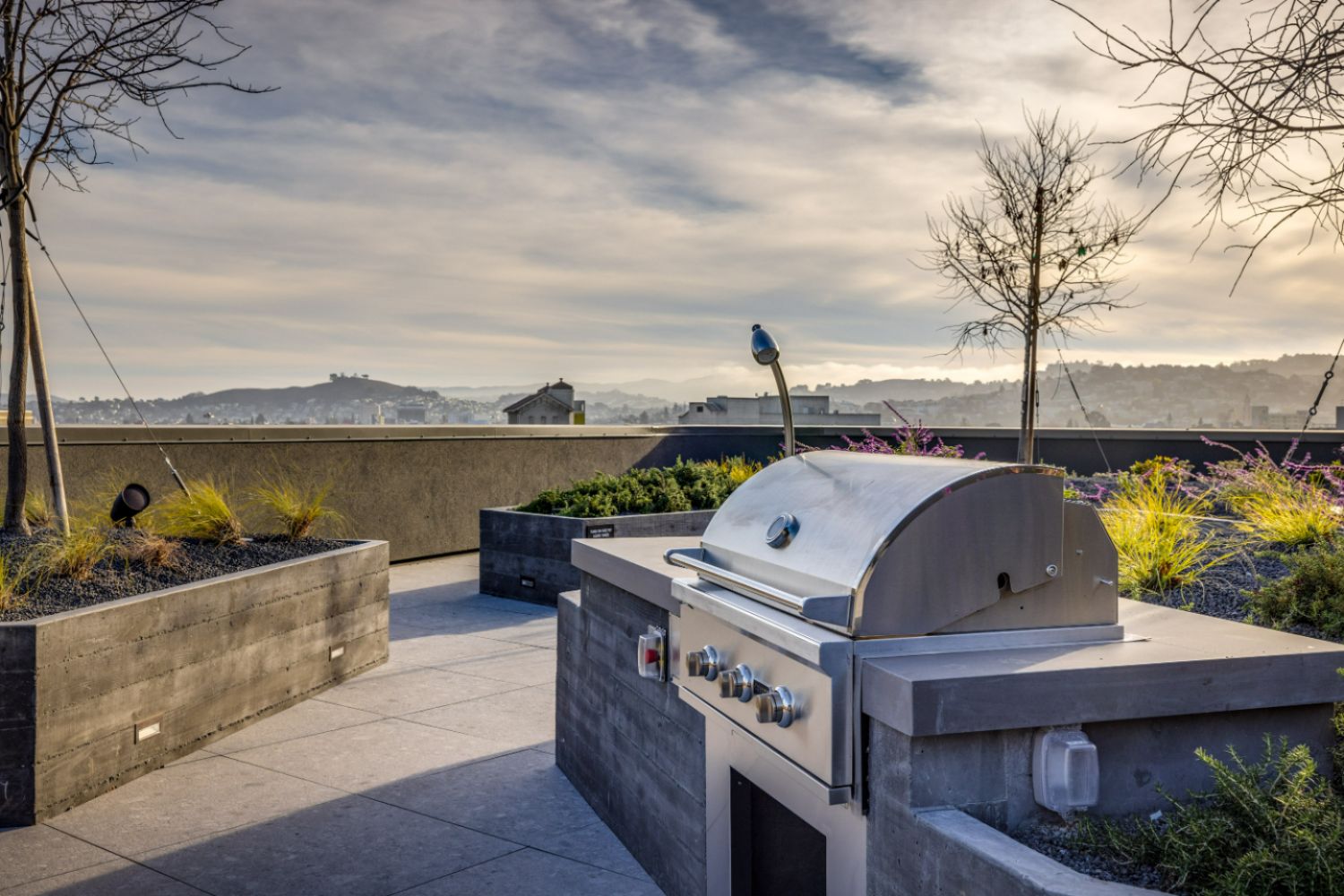 Rooftop grill area with seating and San Francisco skyline views