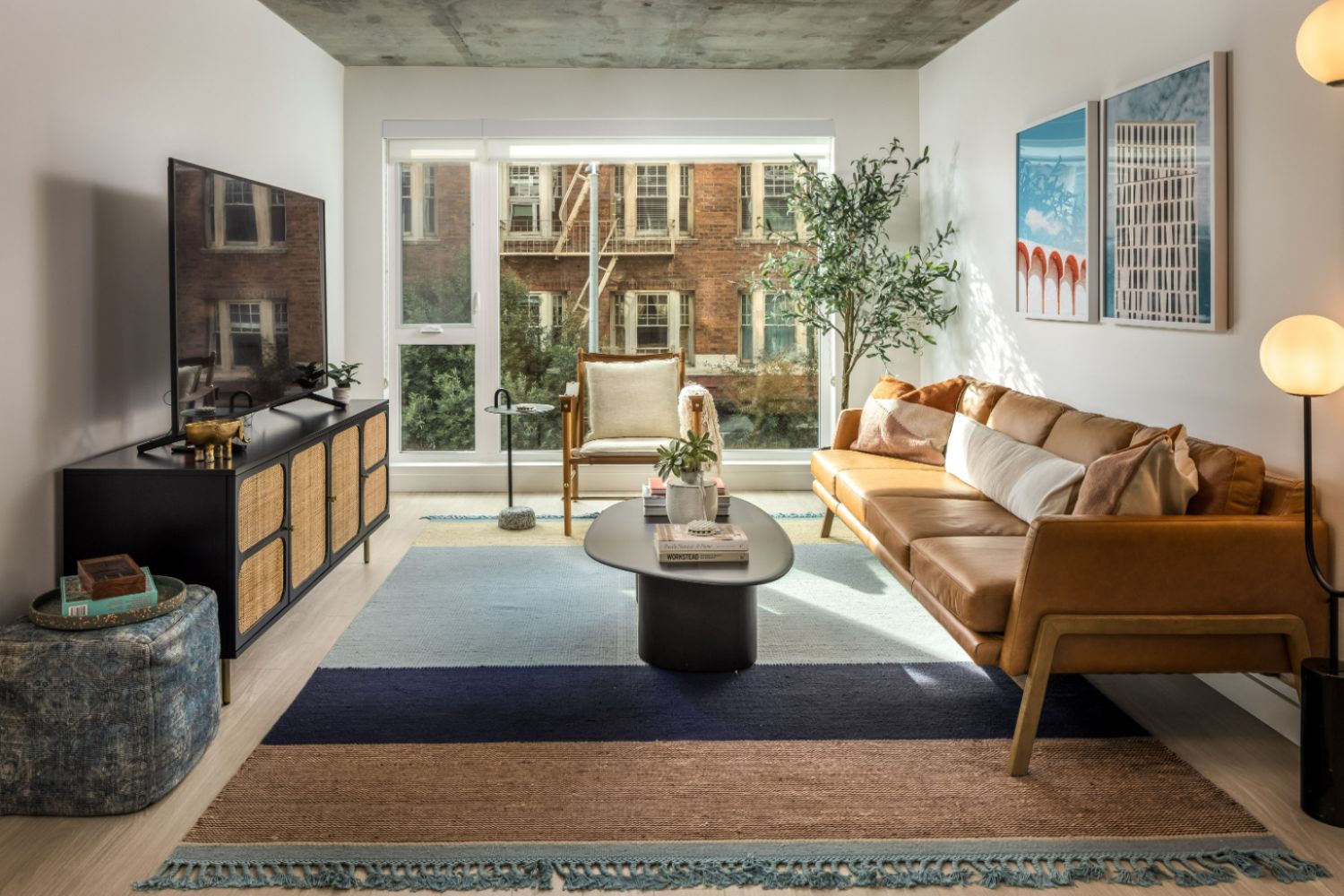 Luxury apartment living room with floor-to-ceiling windows, modern furniture, and natural light in San Francisco apartment