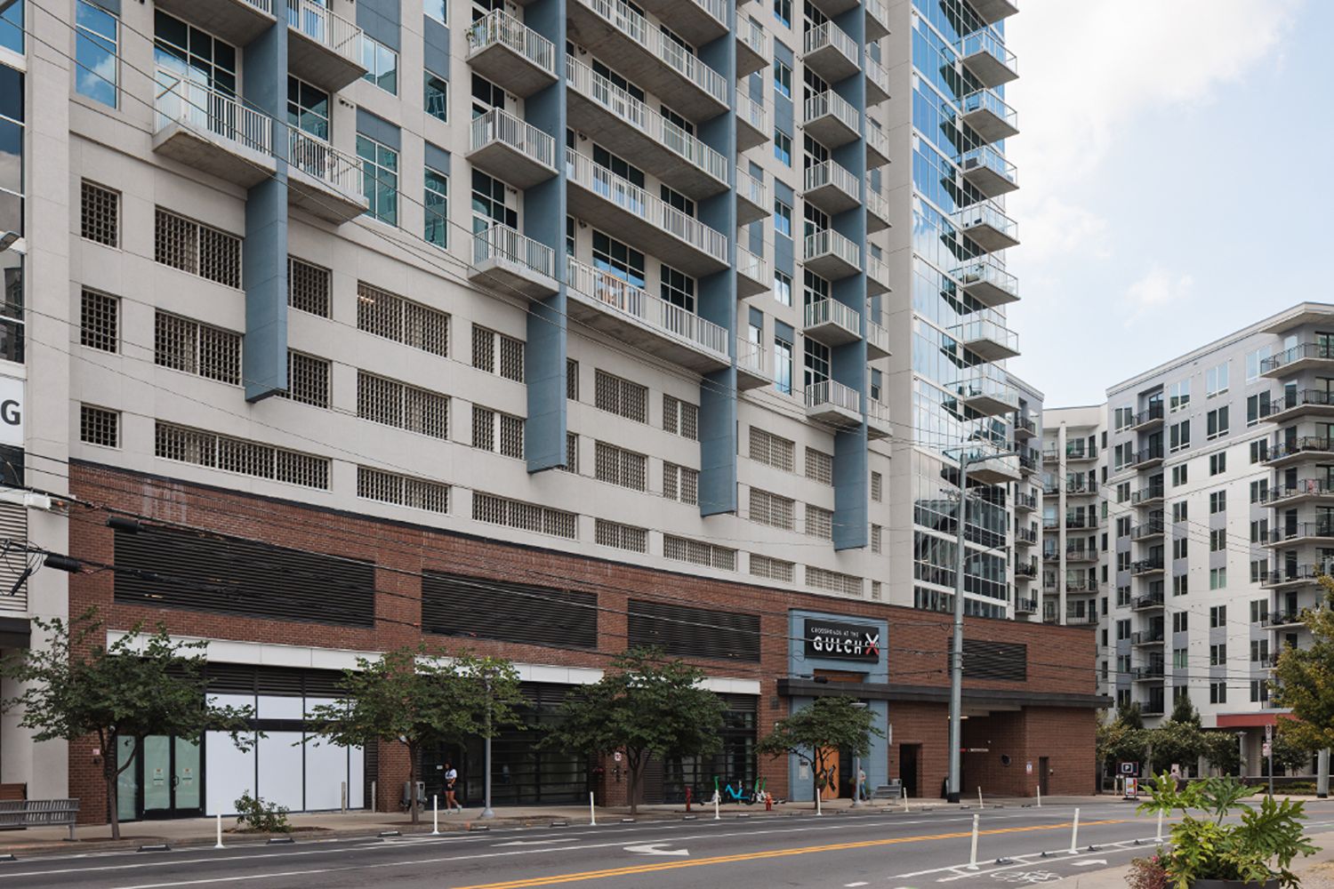 Street-level view of the Crossroads at the Gulch building facade and rows of balconies.