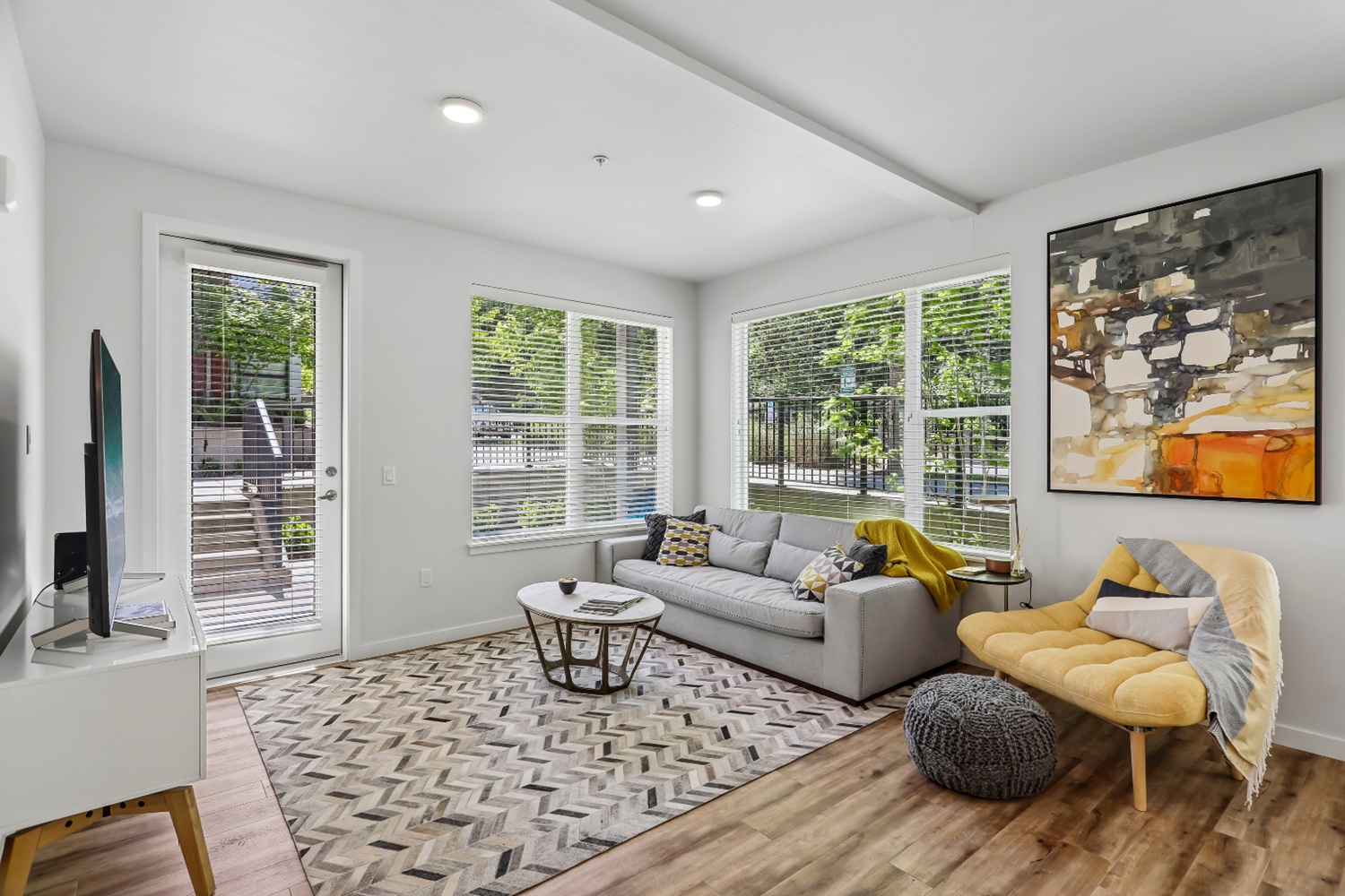 Modern living room in Anthology Apartments with bright windows and stylish decor.