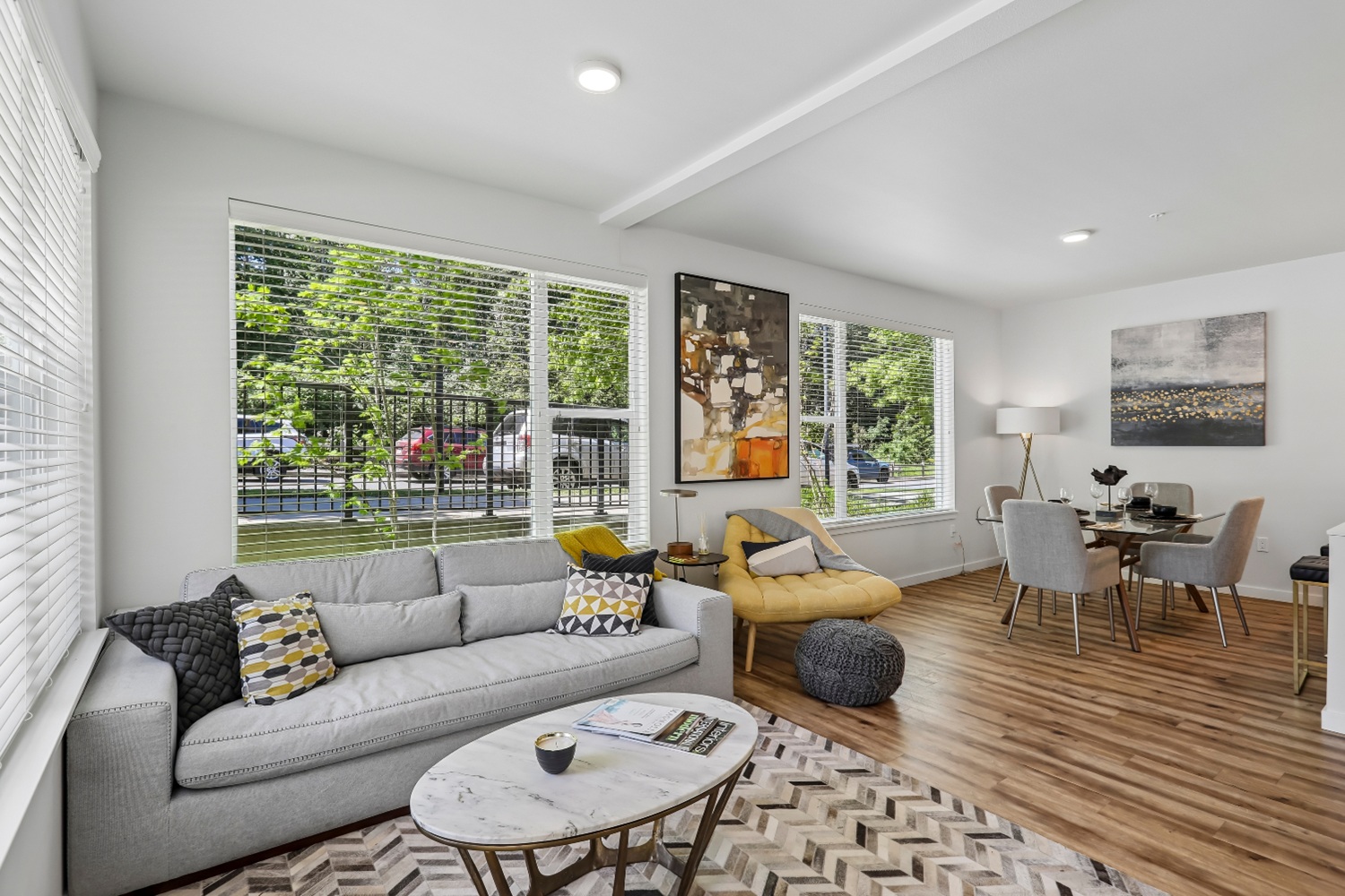 Spacious living area with modern furniture in Anthology Apartments showcasing open living and dining space.
