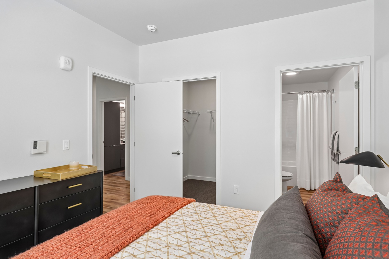 Cozy bedroom in Anthology Apartments with stylish decor and natural light.