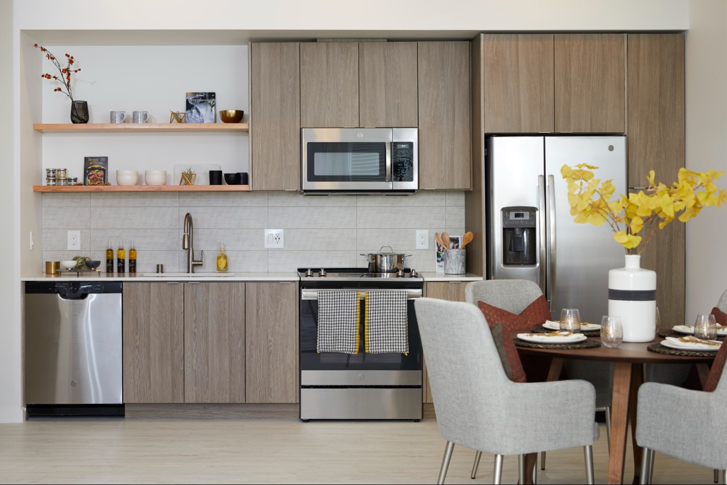 Modern apartment kitchen with stainless steel appliances and quartz countertops