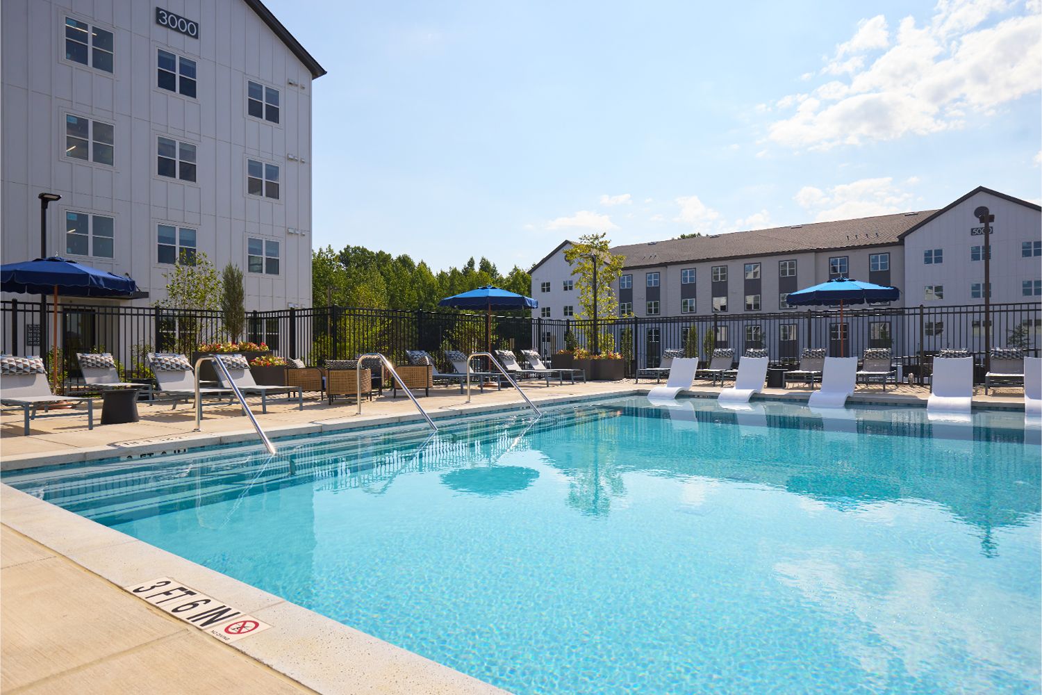 Swimming pool with lounge seating at Alexan Brandywine luxury apartments in Brandywine, MD.