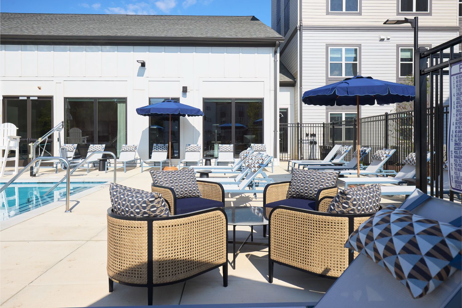 Poolside lounge chairs and umbrellas at Alexan Brandywine luxury apartments in Brandywine, MD.