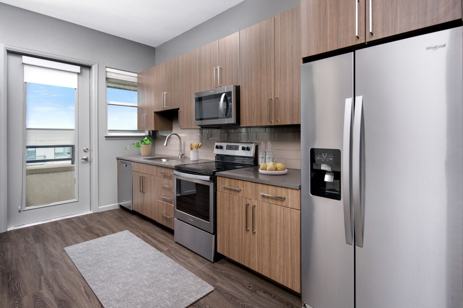 Modern apartment kitchen with stainless steel appliances and quartz countertops