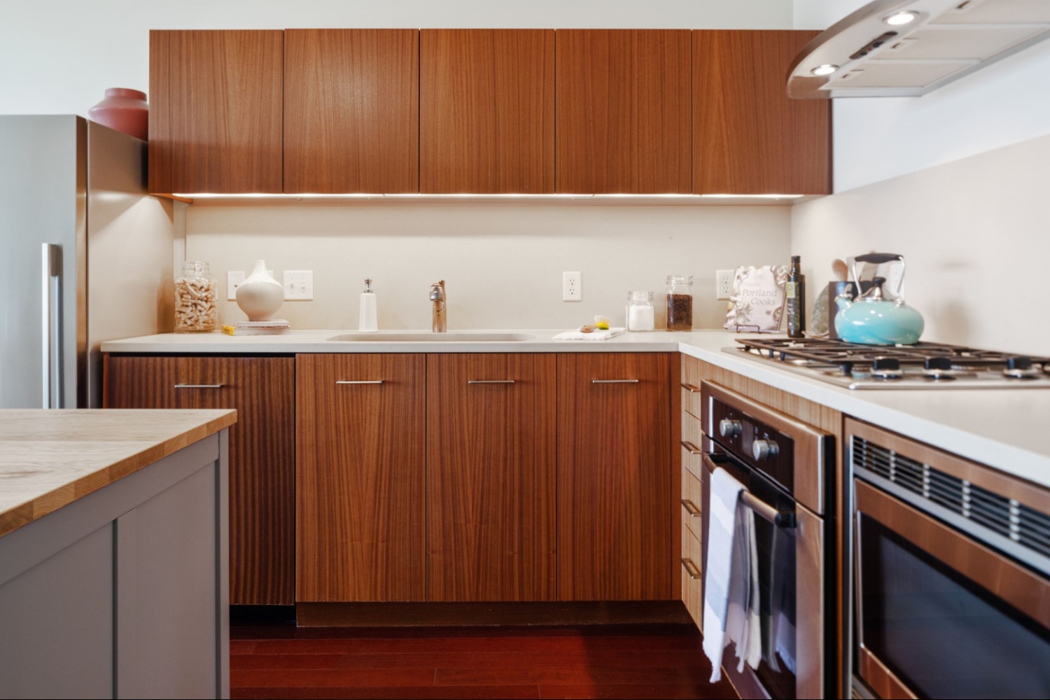 Modern kitchen with wooden cabinets and a gas stove.