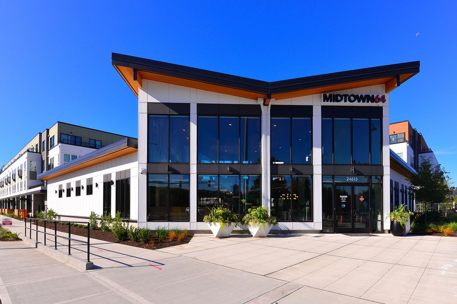 Exterior of the Midtown 64 clubhouse and surrounding landscaping.