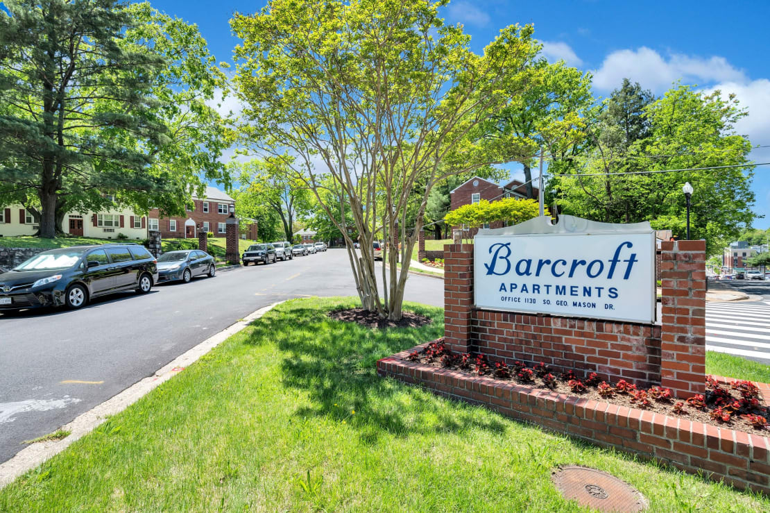 Sign for Barcroft Apartments near a well-maintained street.
