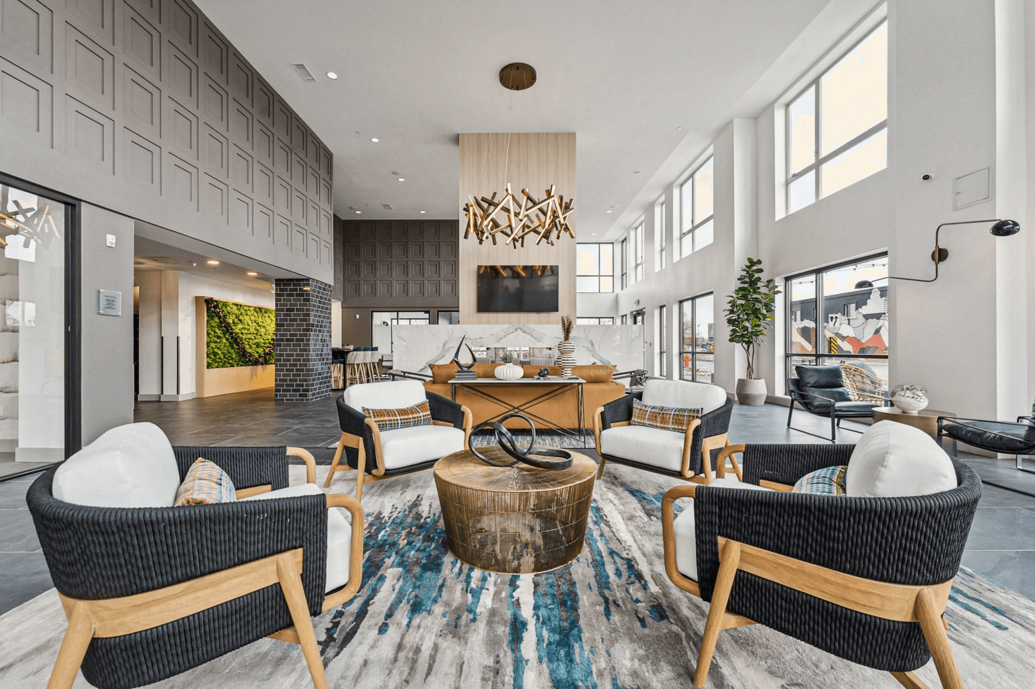 Modern lounge area with cozy seating, large windows, and stylish decor.