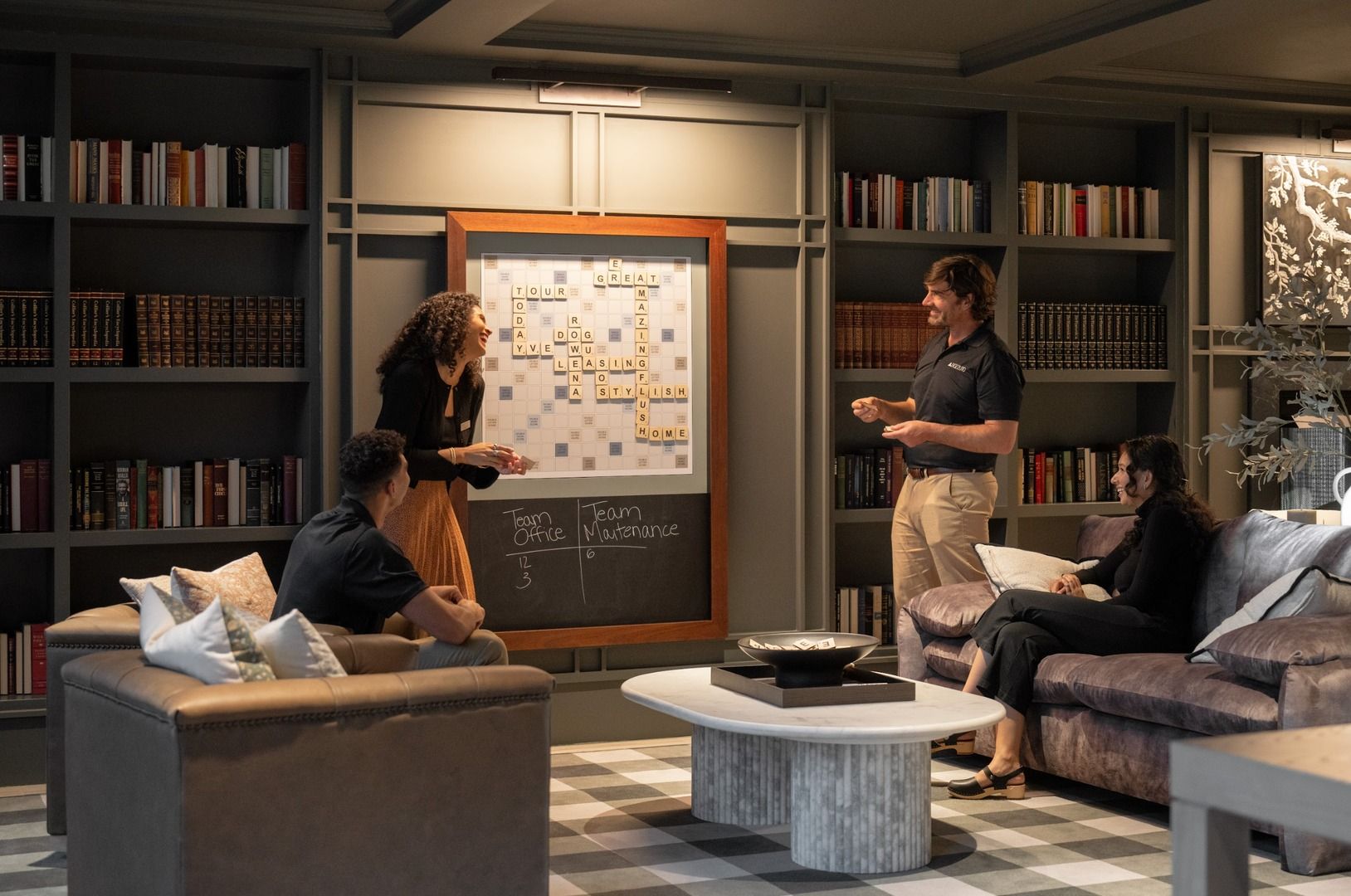 Group meeting in a cozy library setting with a presentation on a whiteboard.
