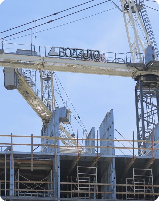 Construction site with a crane and building structure under construction.